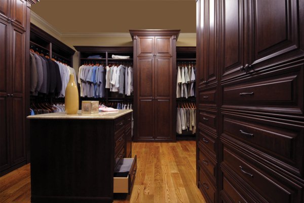 A large custom closet with lots of clothes