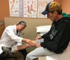 Mario Lee M.D. checks Tim Cline’s healing progress.
