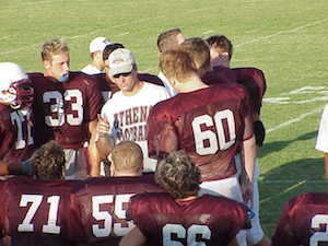 Coach and football players.