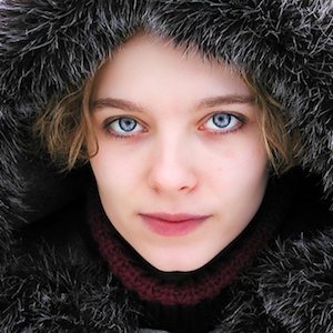 A woman in a winter coat and hat.