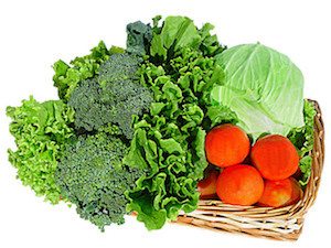 Basket of vegetables: tomatoes cabbage lettuce and broccoli.