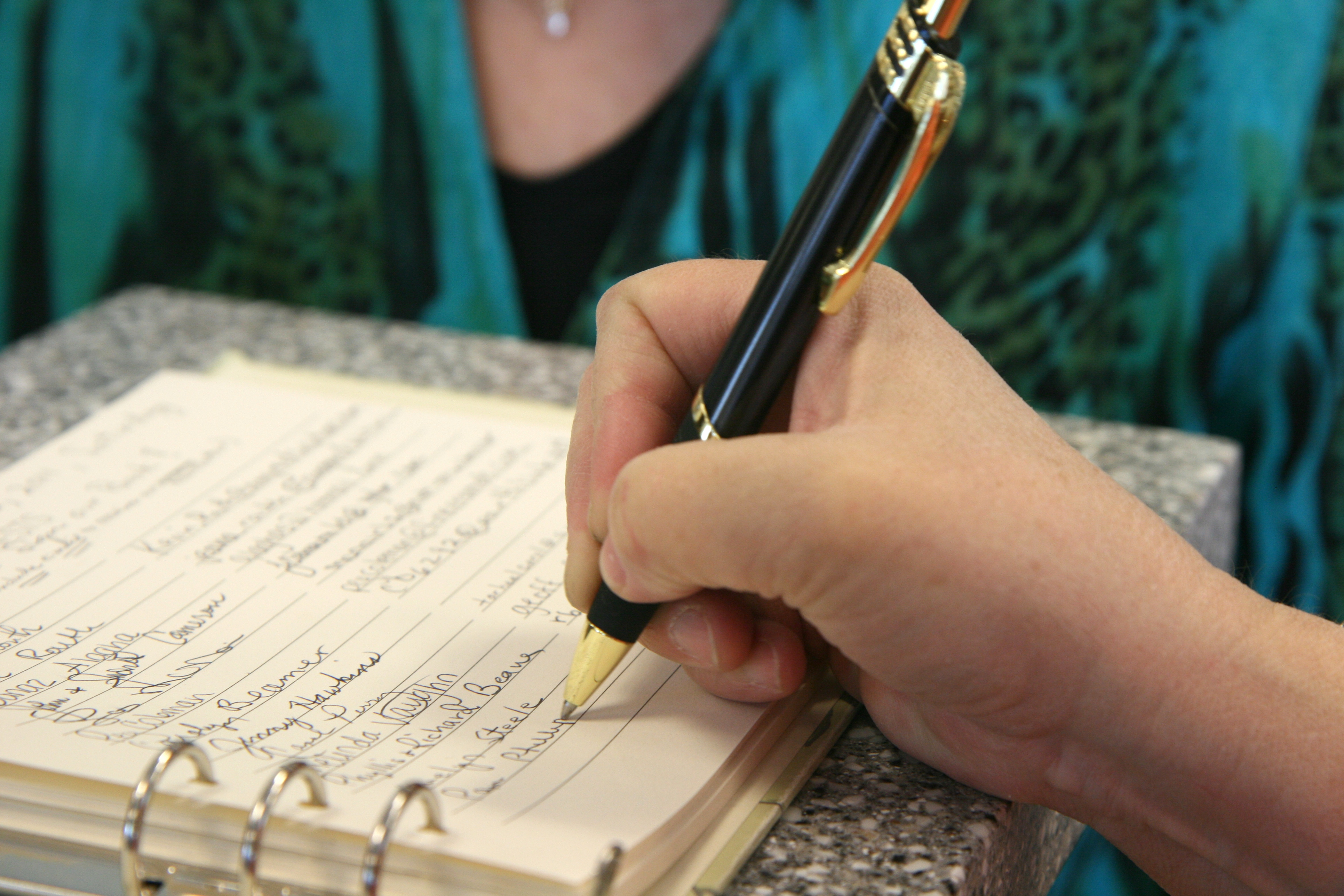 signing a guestbook at funeral