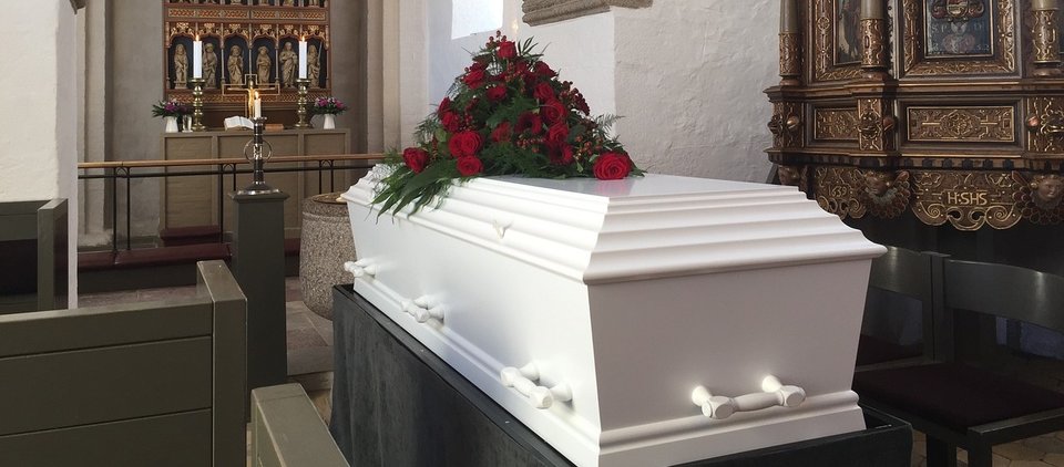 White coffin in church